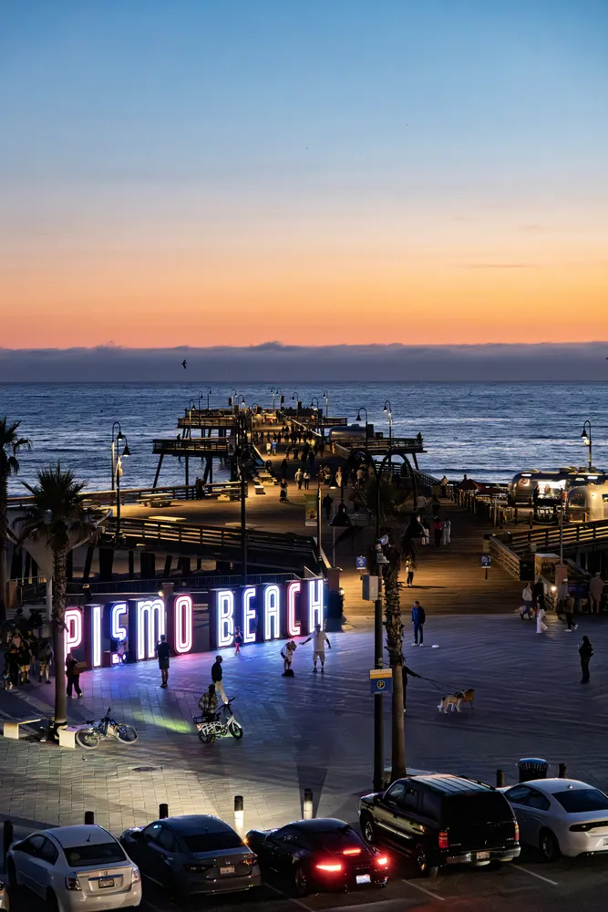 The lit PISMO BEACH sign on the seafront at dusk during CADW 2025