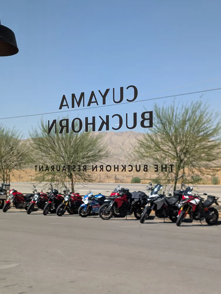 Ducatis parked outside the Cuyama Buckhorn, seen through the restaurant window