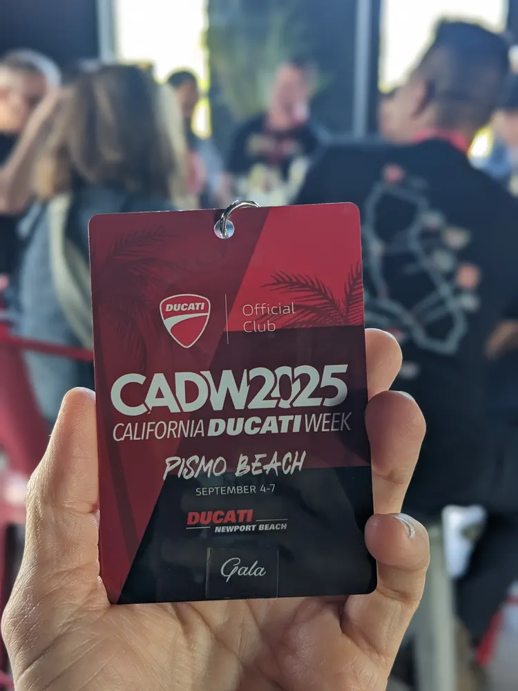 A hand holding the red CADW 2025 gala credential, Pismo Beach, September 4 to 7
