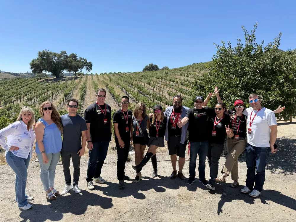CADW 2025 attendees standing in the vineyard rows on the Paso Robles winery tour