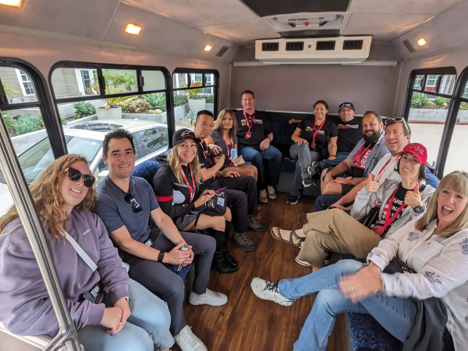 CADW 2025 participants smiling together inside the wine tour bus