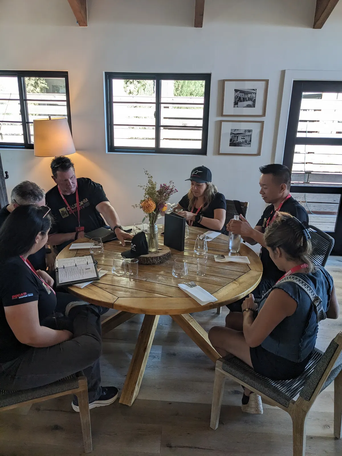 CADW participants seated around a round wooden tasting table