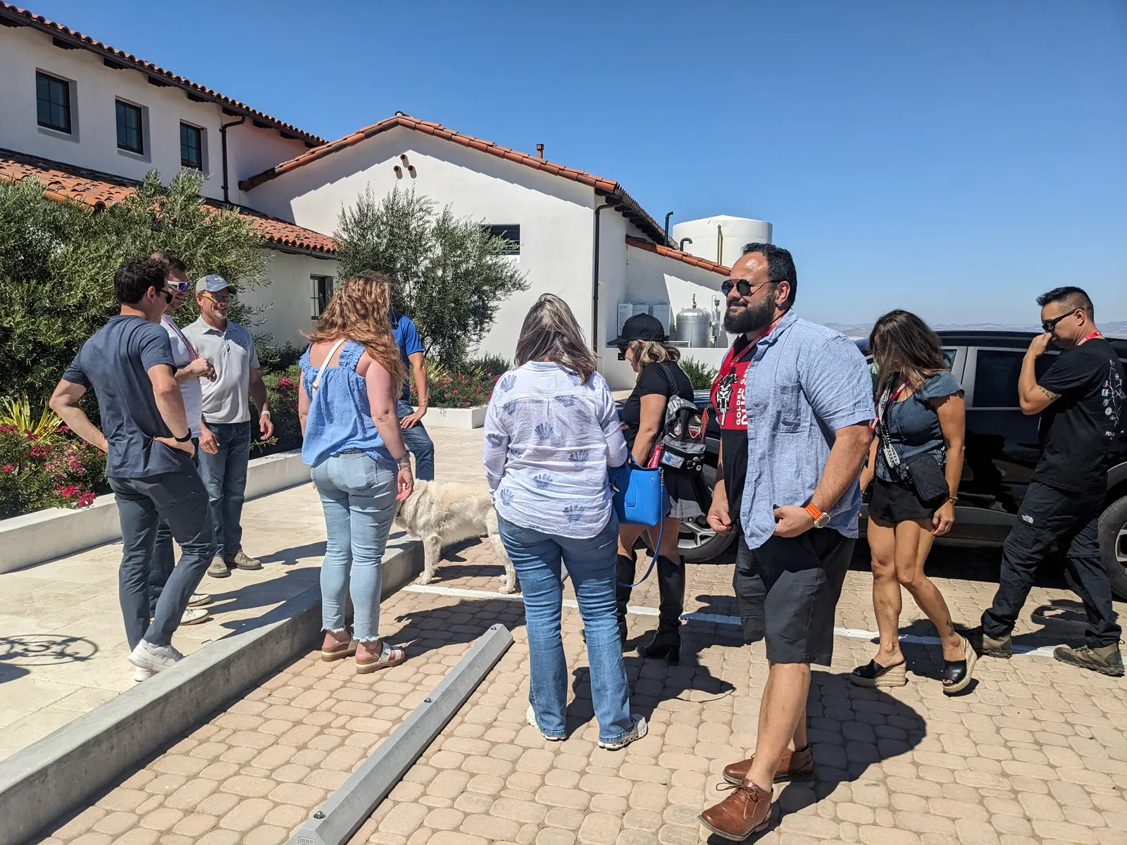 The group arriving in a sunny winery courtyard