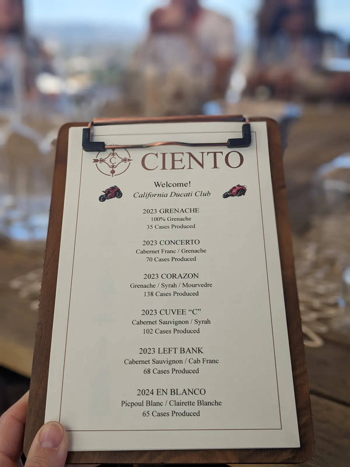 The Ciento Cellars tasting menu held above the terrace table