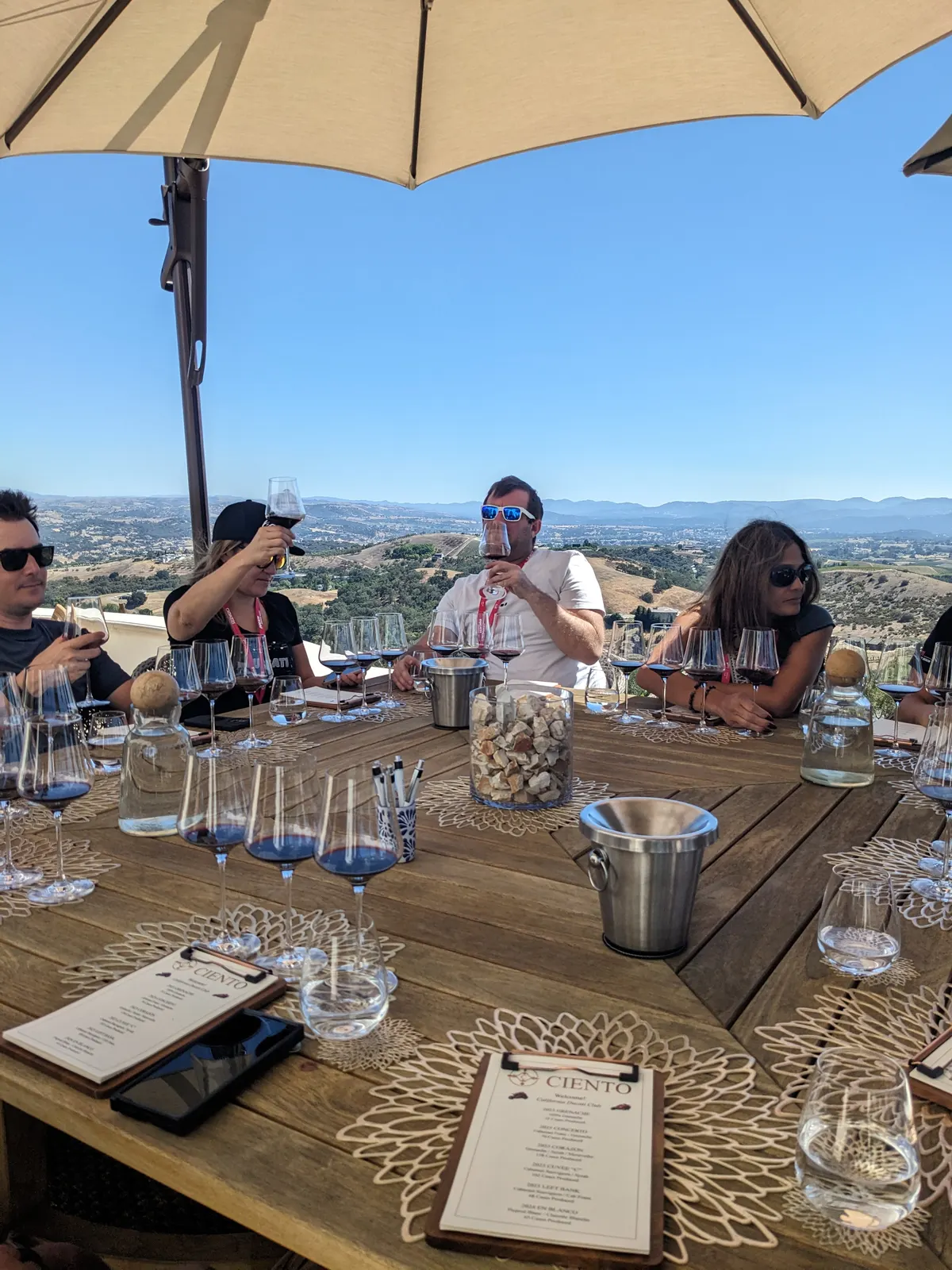 CADW participants seated beneath umbrellas during an outdoor tasting