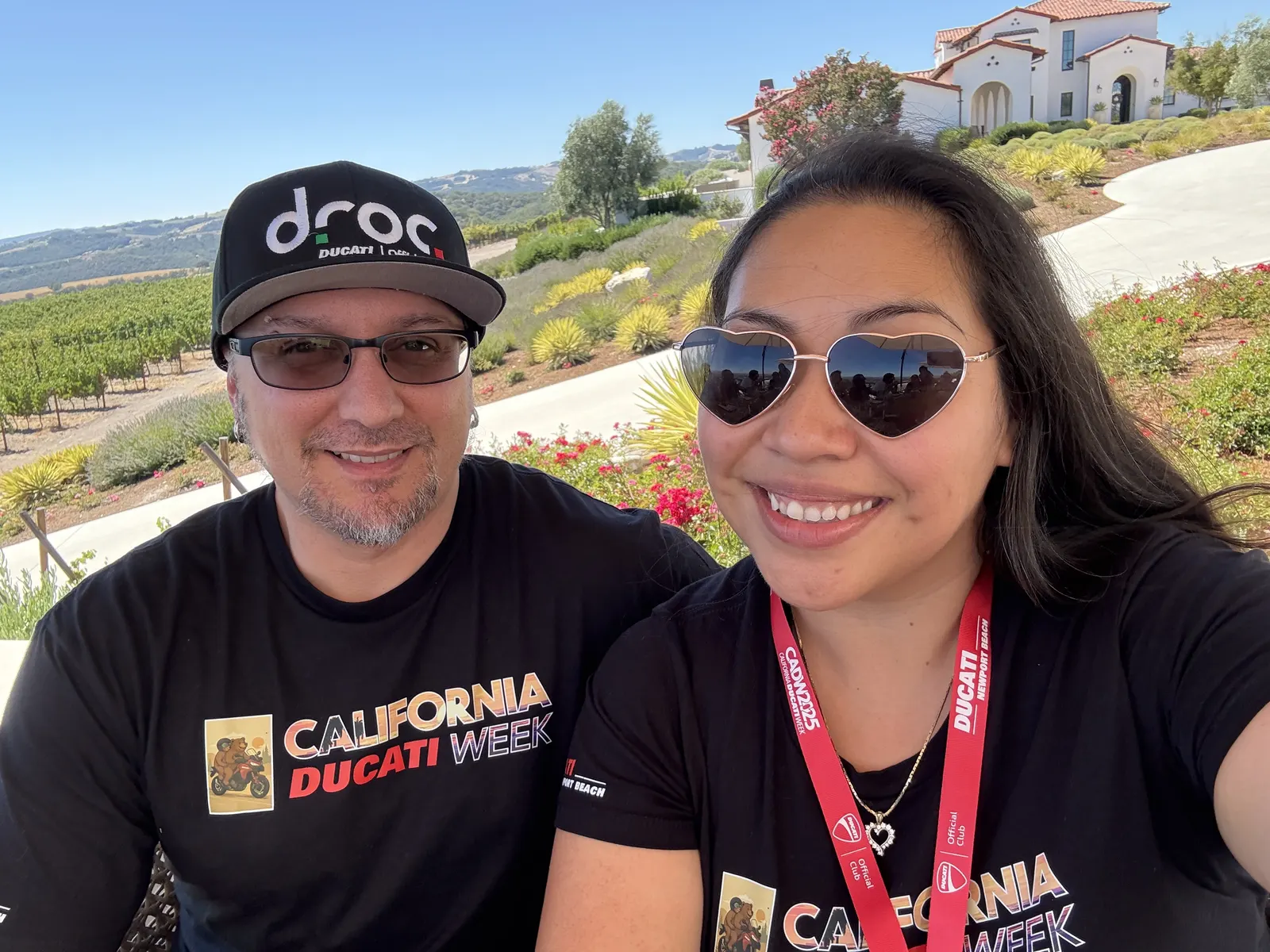 Two Ducati club friends taking a smiling selfie at the winery