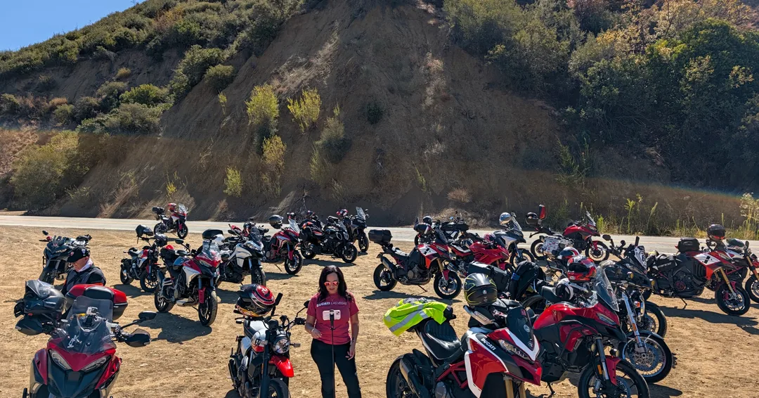 Ducati riders and motorcycles at a hillside stop on Friday Ride A.