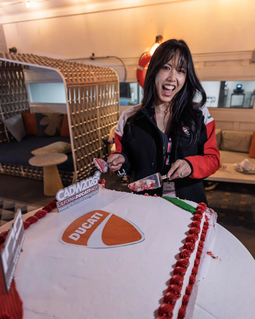 An attendee serving the Ducati cake at the Friday gala dinner.