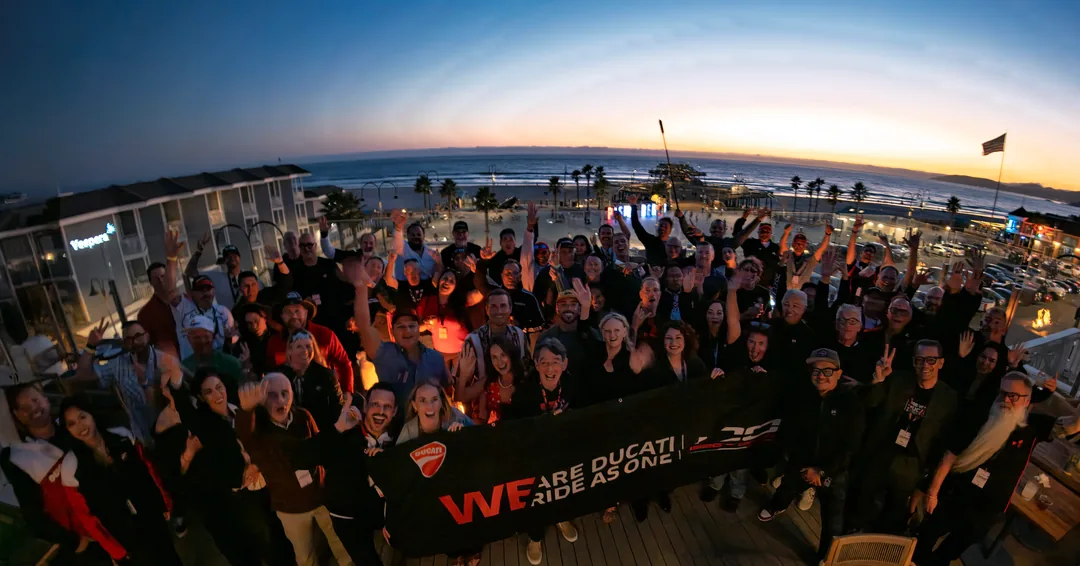 The CADW 2026 gala dinner group gathered under the lights above the ocean.