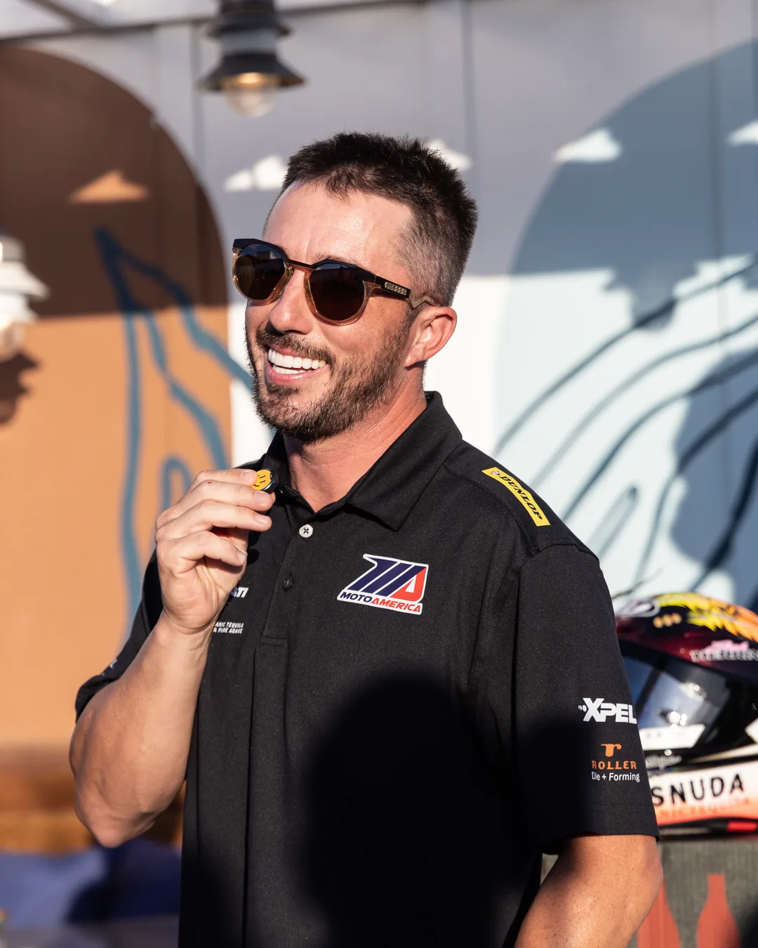 Josh Herrin speaking into a microphone at the Friday meet and greet.