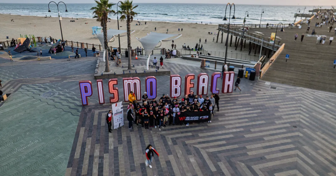 An elevated view of the CADW 2026 group beside the pier and Pismo Beach sign.