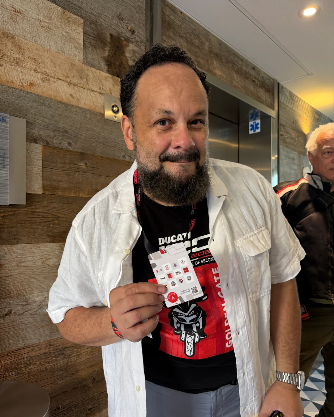 An attendee holding up a playing card at the Thursday reception.