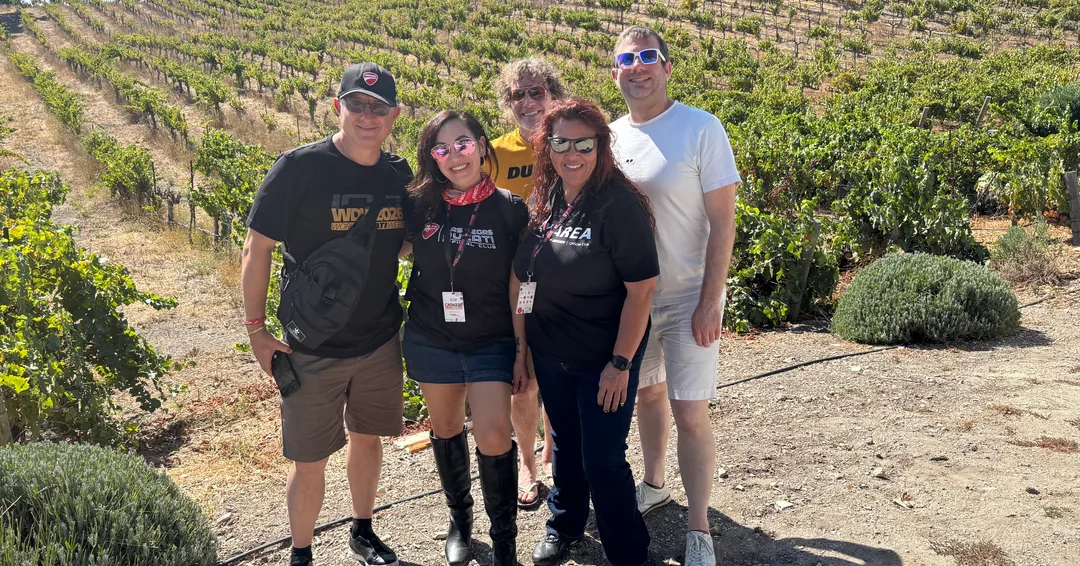 Five friends posing in a vineyard during the Saturday Paso Robles wine tour.