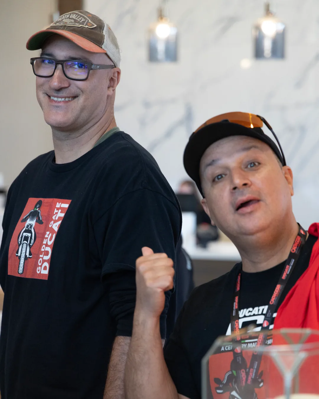 Two friends in Ducati club shirts at the Saturday workshop.