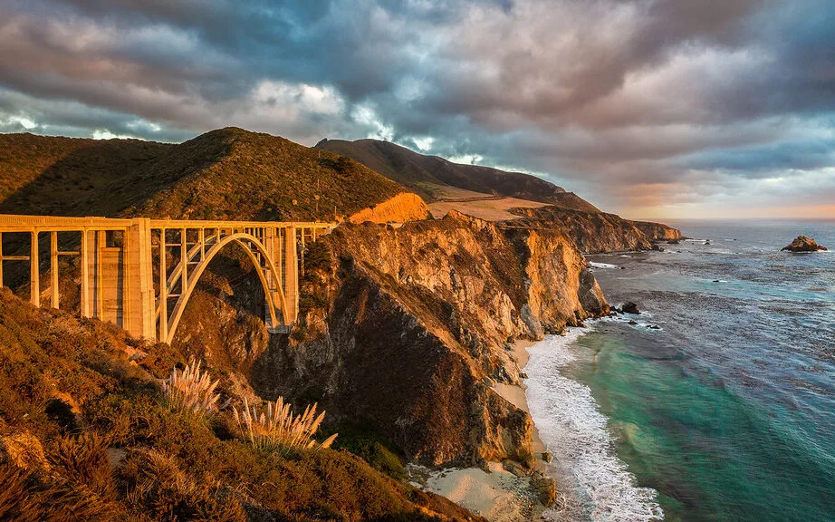 Bixby Creek Bridge arching over the Big Sur coastline at golden hour